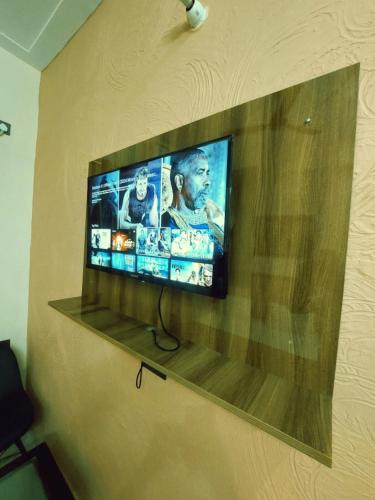 a flat screen tv hanging on a wall at Hotel STAY INN in Haldwāni