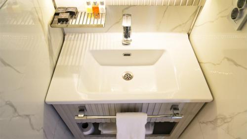 a bathroom with a white sink and a towel at Sky Hill Hotel in Ankara