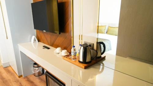 a kitchen counter with a coffee maker on it at Sky Hill Hotel in Ankara