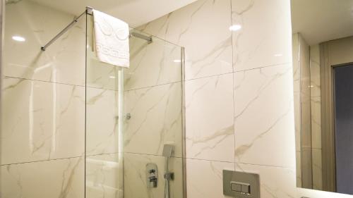 a shower with a glass door in a bathroom at Sky Hill Hotel in Ankara
