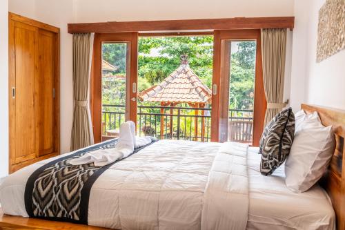 Postel nebo postele na pokoji v ubytování Ubud Ayu