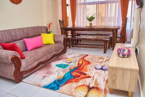 a living room with a couch and a table at Ligen Suites in Kakamega