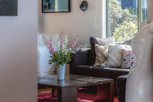 a living room with a couch and a table at Seaview Sanctuary in Onetangi