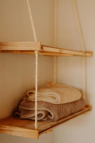 a wooden shelf with some towels on it at Harmony Game Lodge in Middlerus