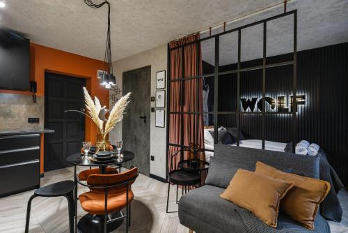 a living room with a couch and a table at Apartament WOLF in Szczawnica