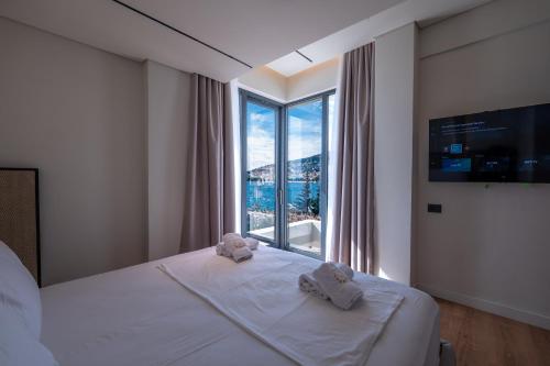 a hotel room with a bed with towels on it at Grand Hotel Saranda in Sarandë