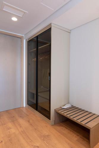 a room with a bench in the corner at Grand Hotel Saranda in Sarandë