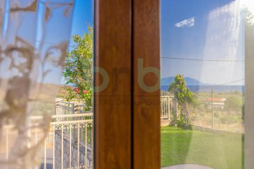a glass door with a view of a yard at Thea Dikella in Dhíkella