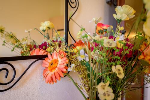 a bunch of flowers in a vase on a wall at Thea Dikella in Dhíkella