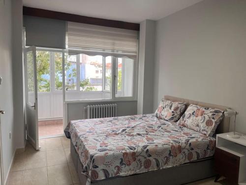a bedroom with a bed and a window at Spacious flat with wide view in Istanbul