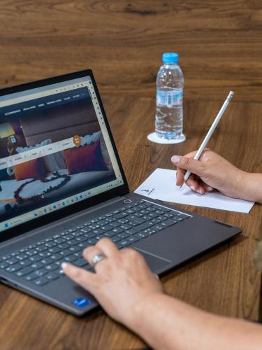 a person sitting at a table with a laptop computer at Kenzi Basma in Casablanca