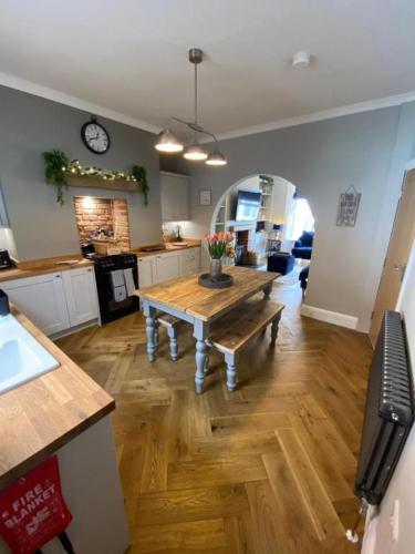 a kitchen with a wooden table in a room at Harbour Heights Whitby in Whitby