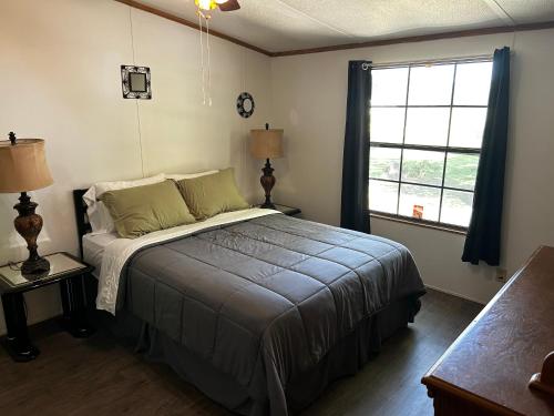 a bedroom with a bed and a large window at Woolen Lake House in Columbia