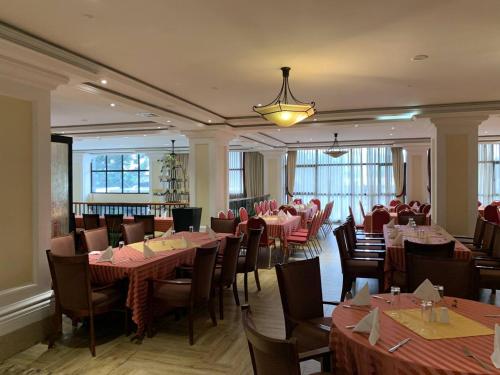 a dining room with tables and chairs and a restaurant at The HUB Hotel in Addis Ababa