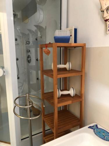 a wooden shelf in a bathroom with a shower at Casa Spisidda Appartamento bilocale "Salina" con vista sulle Eolie in Gioiosa Marea