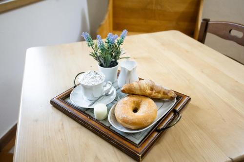 a tray with two donuts and a cup of coffee on a table at Rurale Home & Garden in Montella