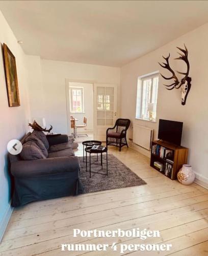 a living room with a couch and a table at Gatekeepers house in Svennerup