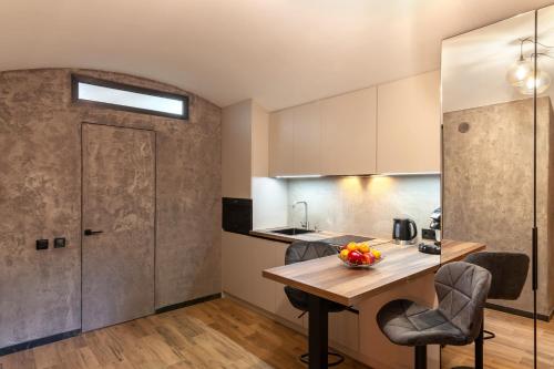 a kitchen and dining room with a table and chairs at Royal Hot Jucuzzi Apartment in Lviv
