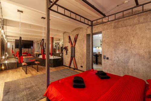 a bedroom with a red bed in a room at Royal Hot Jucuzzi Apartment in Lviv