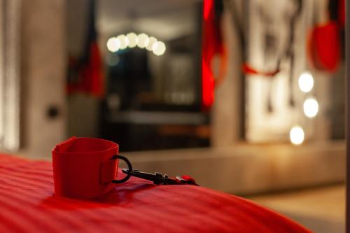 a red cup sitting on top of a table at Royal Hot Jucuzzi Apartment in Lviv
