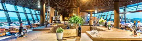 a restaurant with tables and chairs and large windows at Hotel Olympia Sky in Vodice