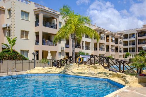 a swimming pool in front of a building at Oliva Poolside Residence by Nomads in Paphos