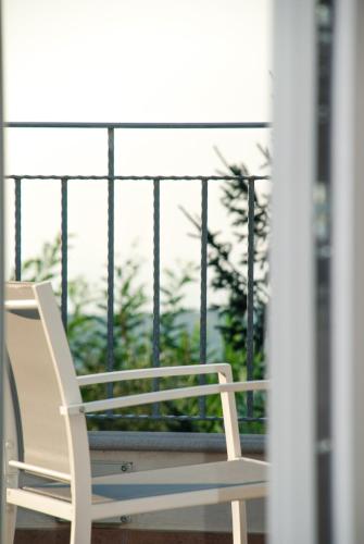 a white chair sitting on a balcony at B&B Il Giardino di Circe - Filadelfia (VV) in Filadelfia