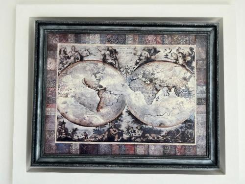 a framed picture of the world on a wall at Home in Center with jacuzzi in Ivano-Frankivsʼk