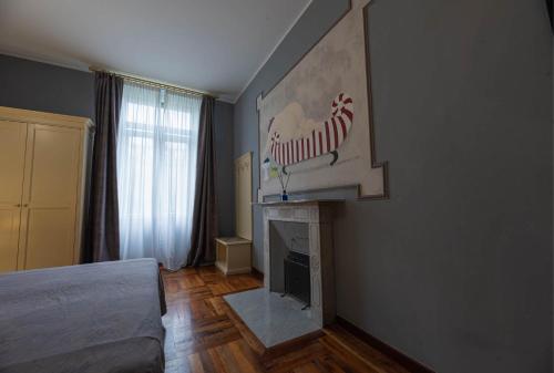 a room with a fireplace with a zebra sign on the wall at Apartments Torino Porta Susa PLUS in Turin