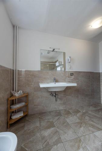 a bathroom with a sink and a mirror at Apartments Torino Porta Susa PLUS in Turin