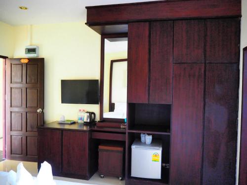 a room with a desk with a computer and a mirror at Morakot Lanta Resort in Ko Lanta