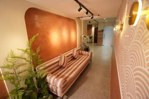 a couch in a hallway with a wall at An Nguyen Boutique Hotel in Hanoi