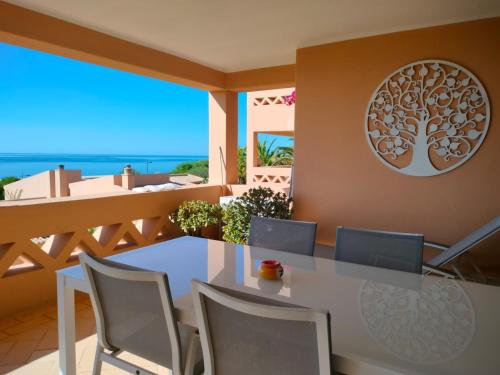 a dining room with a table and chairs at Apartamentos Turísticos Buganvilia in Lagos