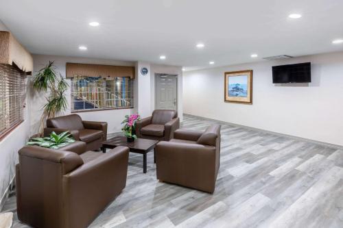 a waiting room with two chairs and a tv at Days Inn by Wyndham Baytown TX in Baytown