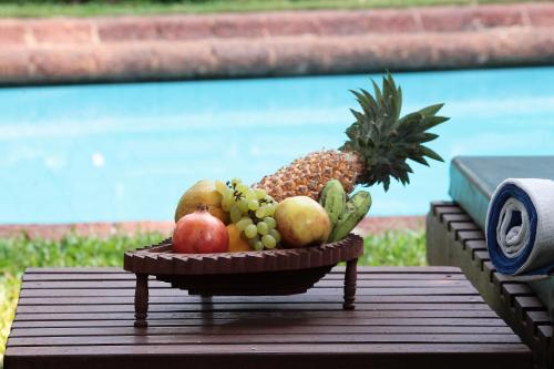 a bowl of fruit sitting on a table at Presa di Goa - Managed by Smith and Appy in Calangute