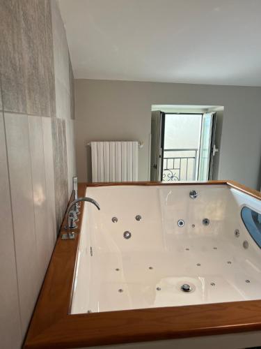a large bath tub in a room at Cataleya comfort room in Aiello del Sabato