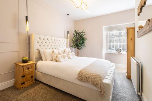 a bedroom with a large white bed and a window at Host & Stay - Yule House in Alnwick