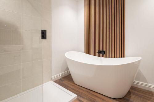 a white bath tub in a bathroom with a shower at Host & Stay - Yule House in Alnwick