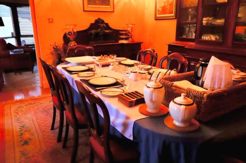 a dining room table with a blue and white table cloth at Mossvale Lodge Country House Bed and Breakfast in Antrim