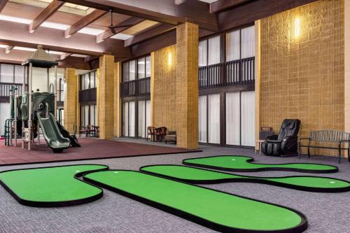 a gym with a slide and a playground at Ramada by Wyndham Alpena in Alpena