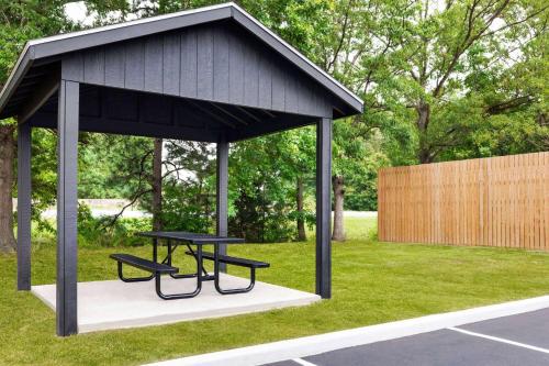 a picnic shelter with two benches in a park at Wingate by Wyndham Salisbury in Salisbury