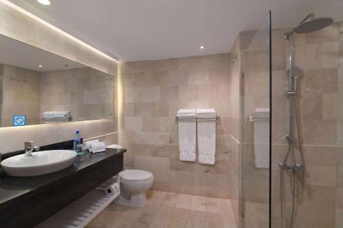 a bathroom with a toilet and a sink and a shower at Wyndham Alltra Samana All Inclusive Resort in Las Galeras