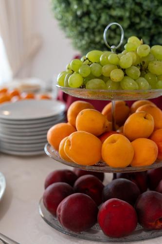 a three tiered display of fruit on a table at Hotel Sa Pedra in Murta Maria