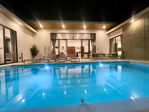 a large swimming pool with blue water in a building at Baan Saint-Tropez Seaview Villa Ko Samui Private Villa in Bophut 