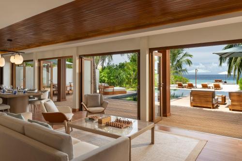 an open living room with a view of the ocean at Huvafen Fushi Maldives in North Male Atoll