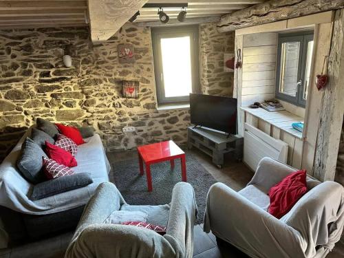 a living room with two couches and a television at Chalet confortable à Ascou avec vue sur la montagne in Ascou