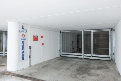an empty garage with sliding doors in a building at Club Hotel e Residence La Vela in Nago-Torbole