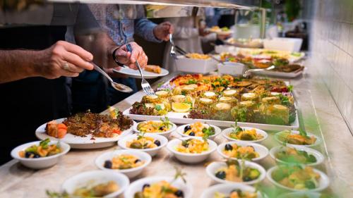 a buffet line with plates of food and bowls of food at Instytut Zdrowia Sofra FIT & SPA in Mielno