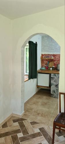 an archway in a room with a table and a window at Budur Guest House in Ijevan
