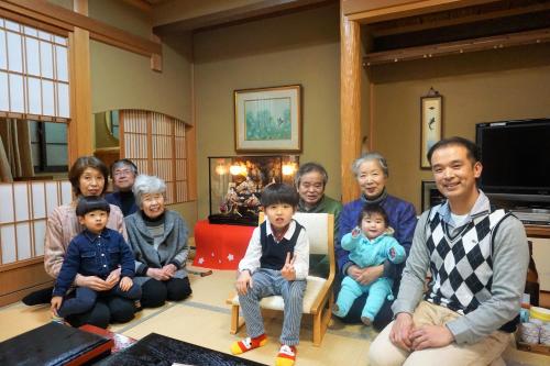 a family posing for a picture in a living room at Morizuya in Toyooka